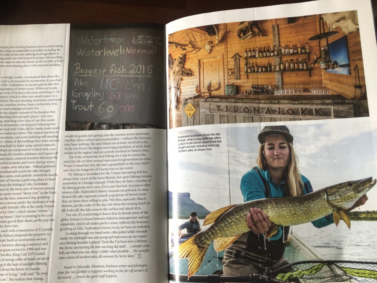 Large fish signs and bar in fishing camp Tjuonajokk in Swedish Lapland, girl with pike fish caught while fly fishing in Sweden.
