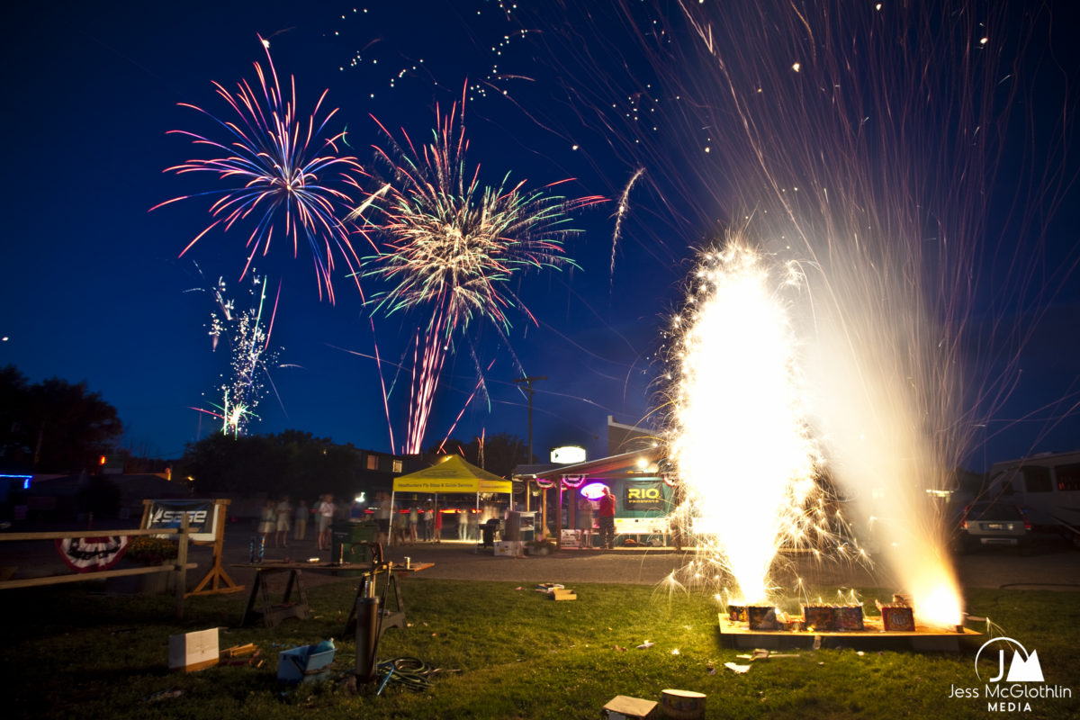 Fireworks exploding at night in front of a shop in Montana.