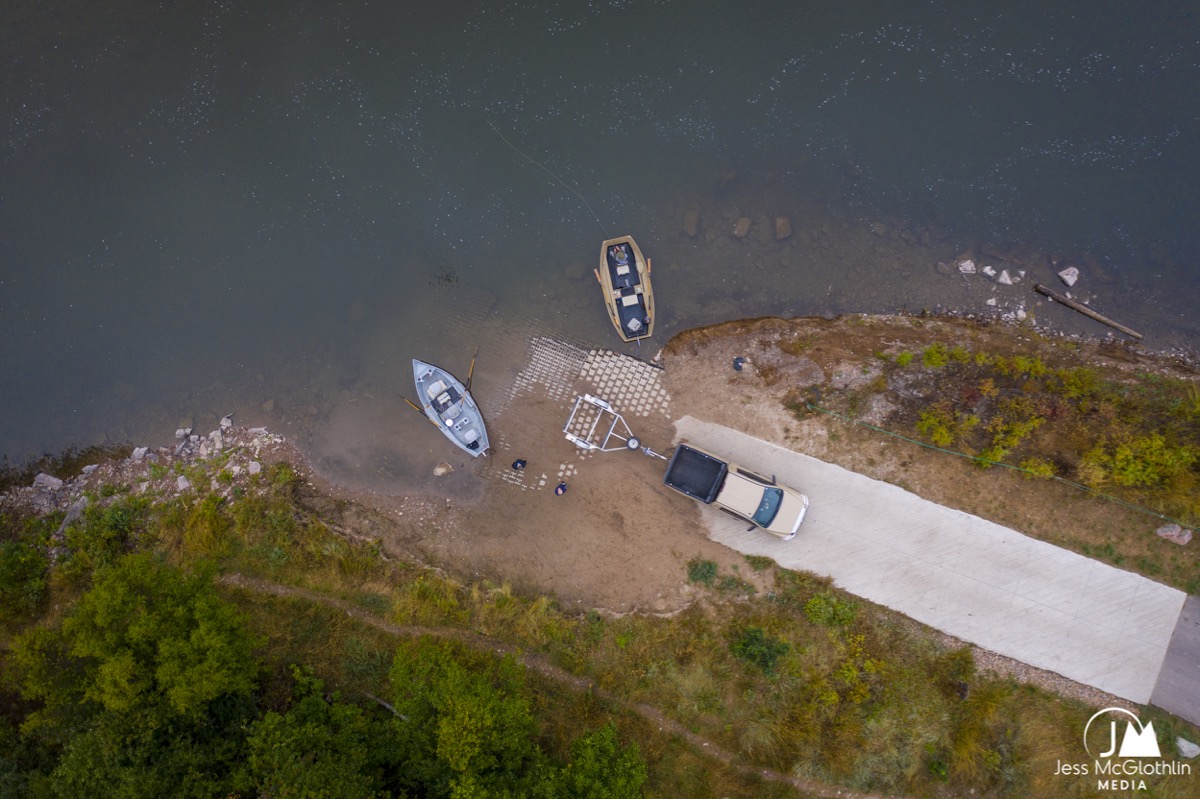 Aerial drone photograph of a boat ramp with drifts boats for fly fishing in Missoula, Montana, in the fall.